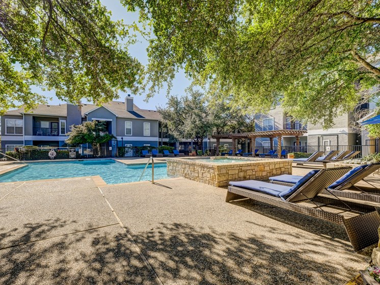 Pool with poolside loungers, Grilling area, and cabanas